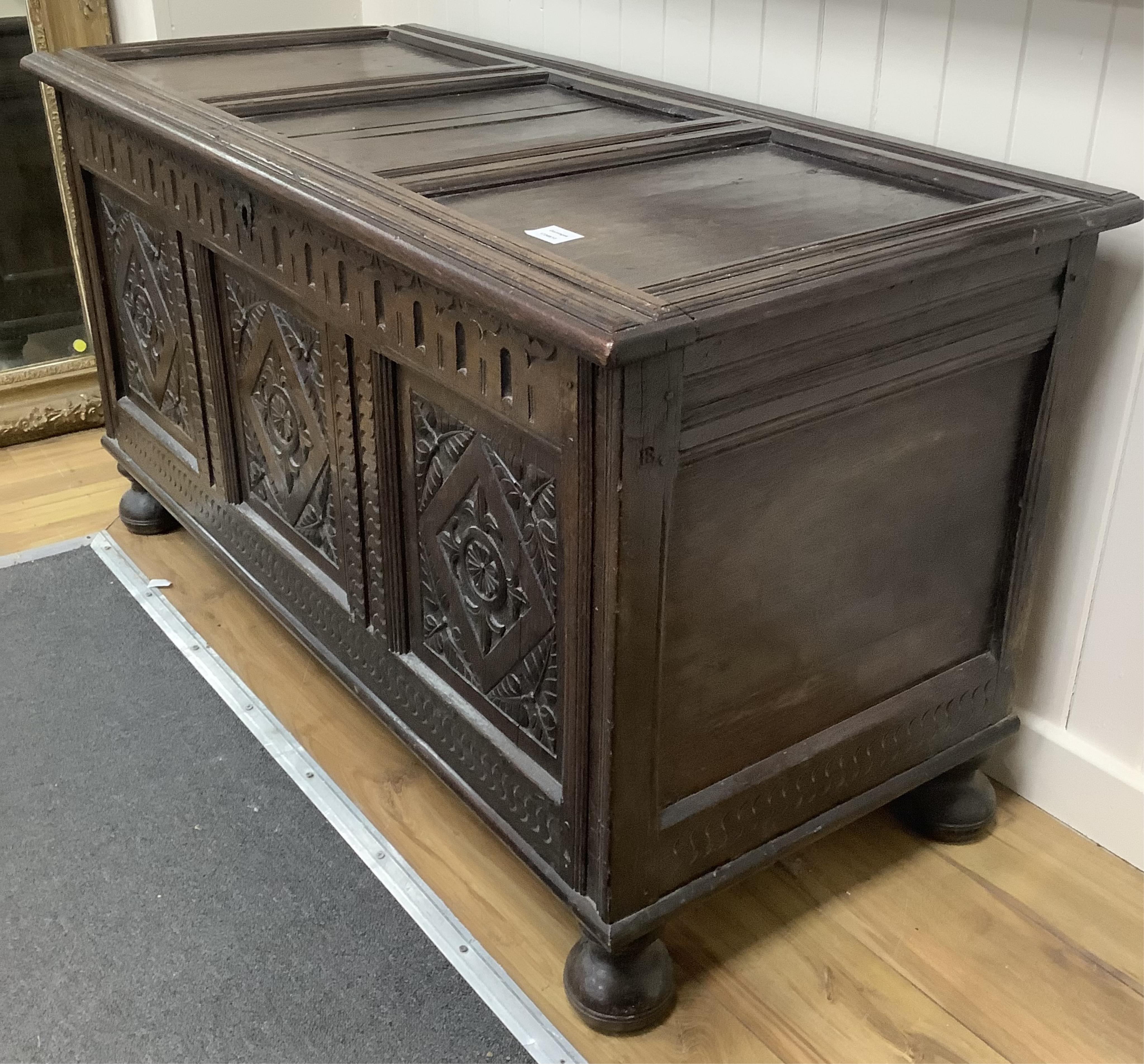 A 17th century and later carved oak coffer, width 128cm, depth 58cm, height 68cm. Condition -fair